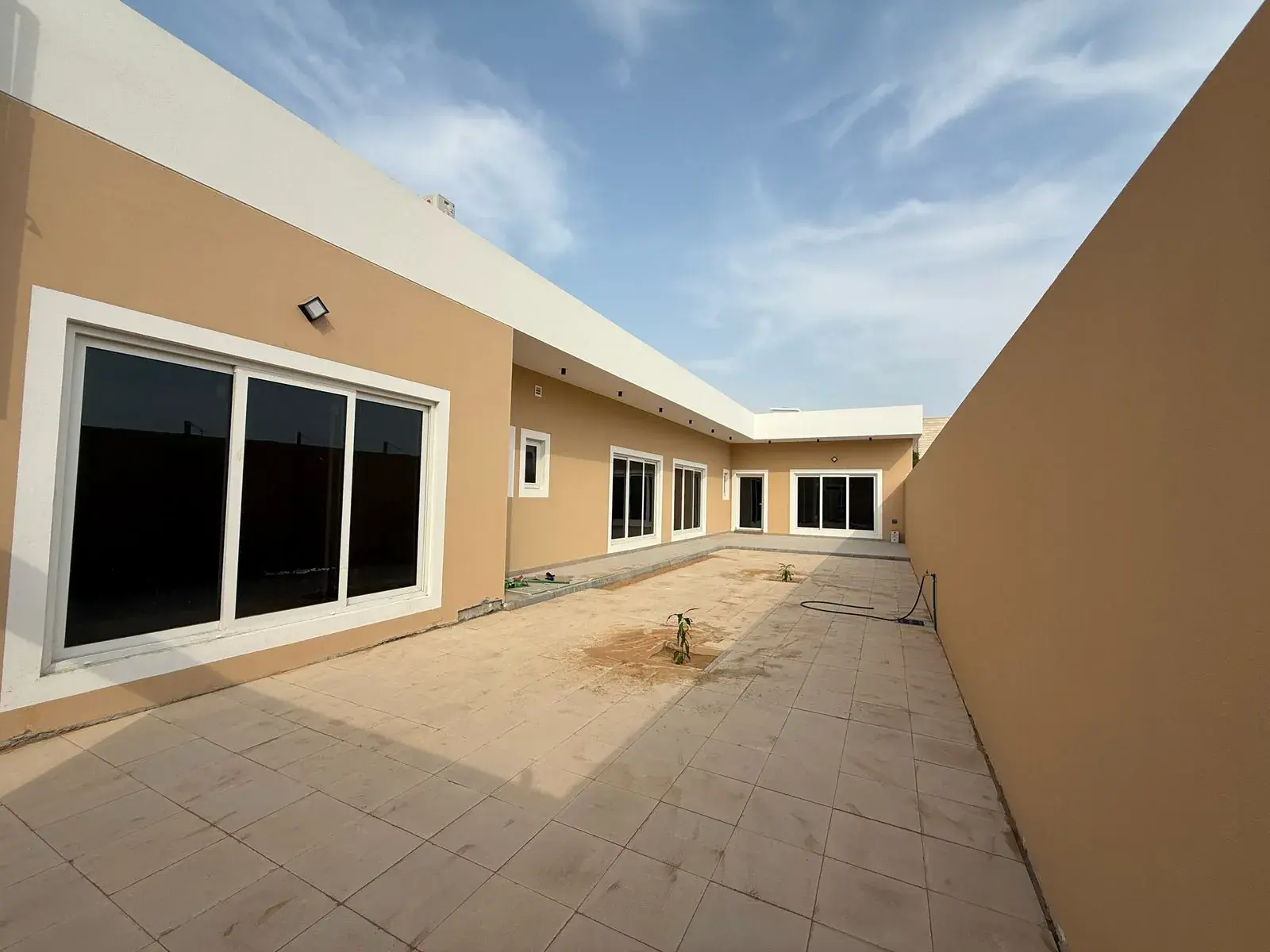 Villa courtyard and side wing with large windows