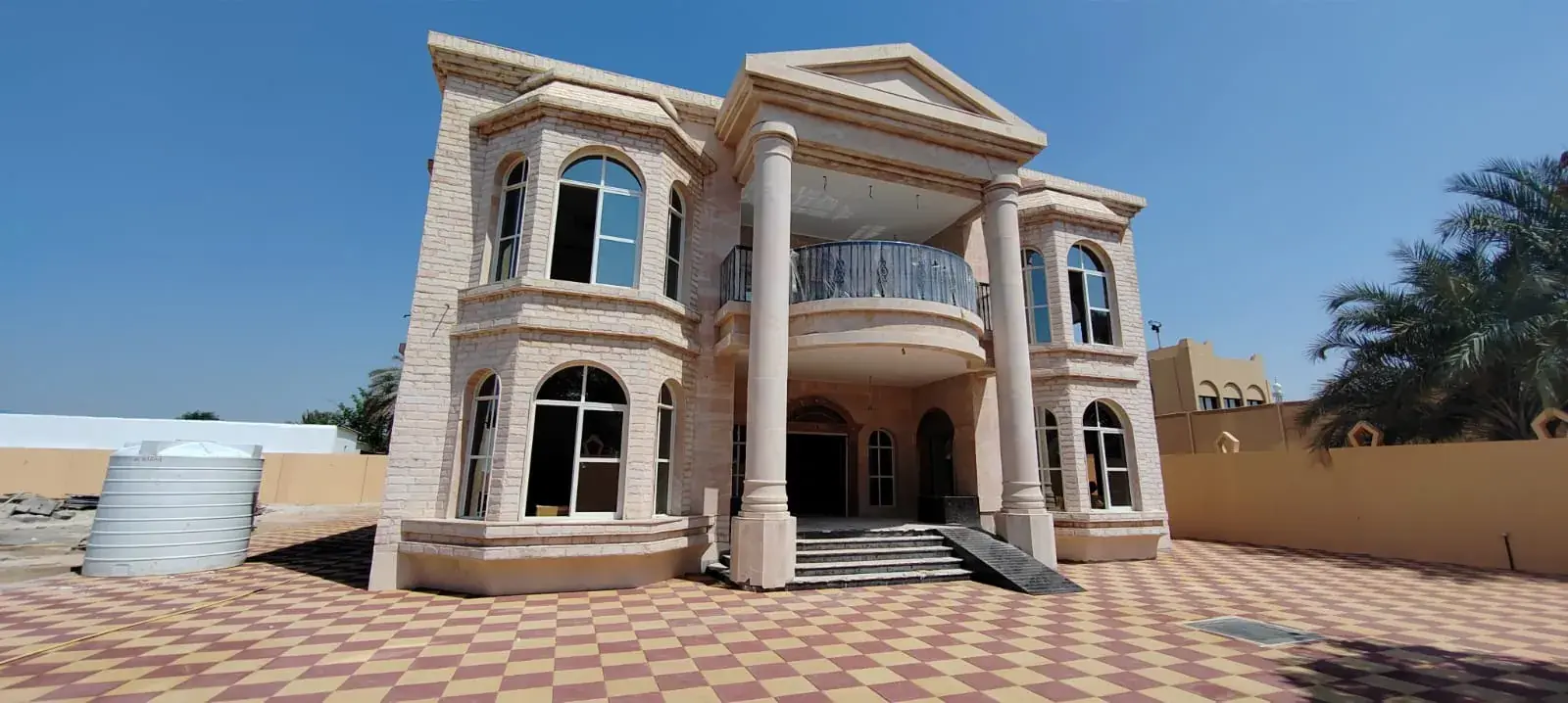 Two-storey classical villa with columns and arched windows