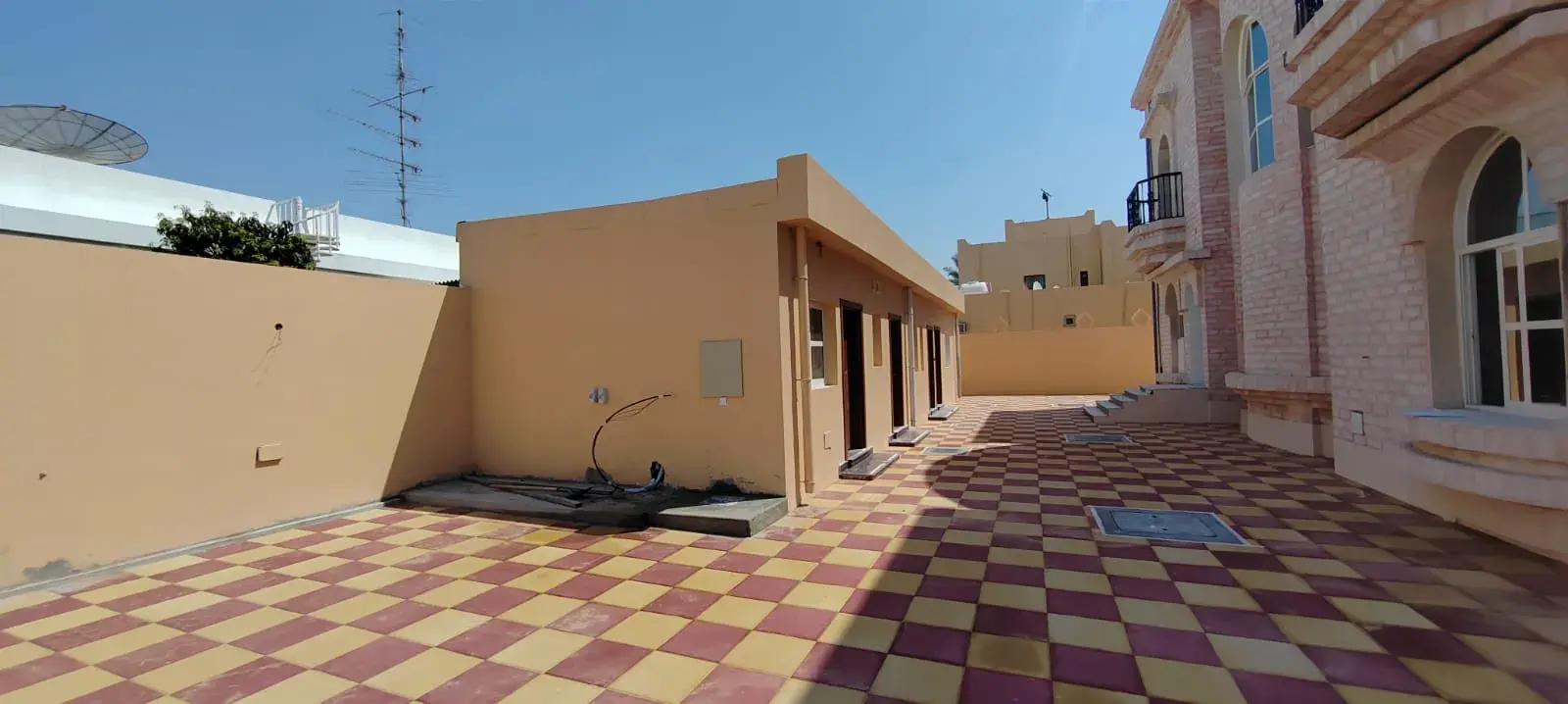 Villa annexe and courtyard with chequered paving