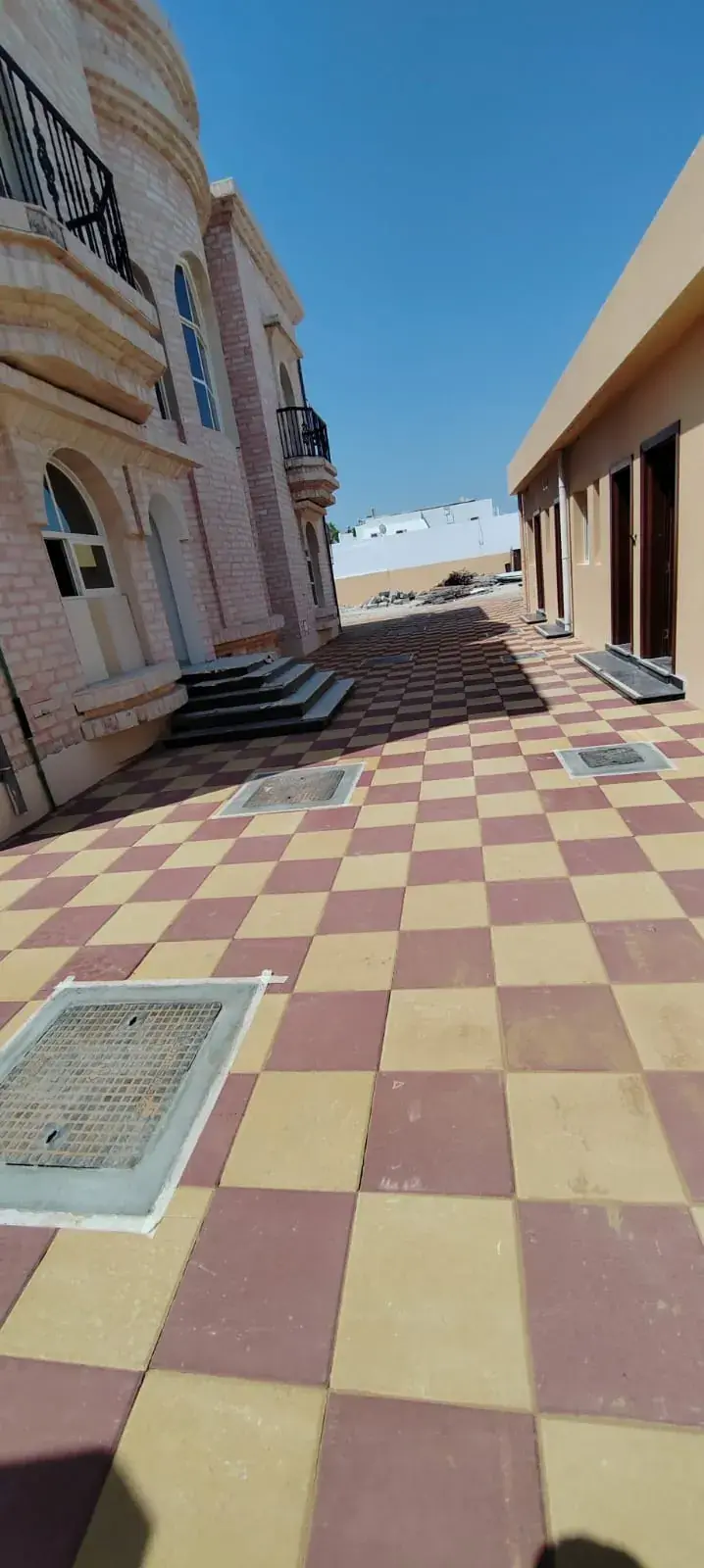 Chequered paving along the side of a villa