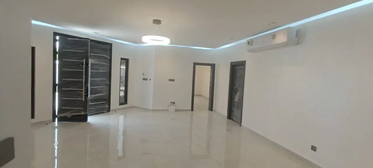 Finished hall with cove lighting and split AC