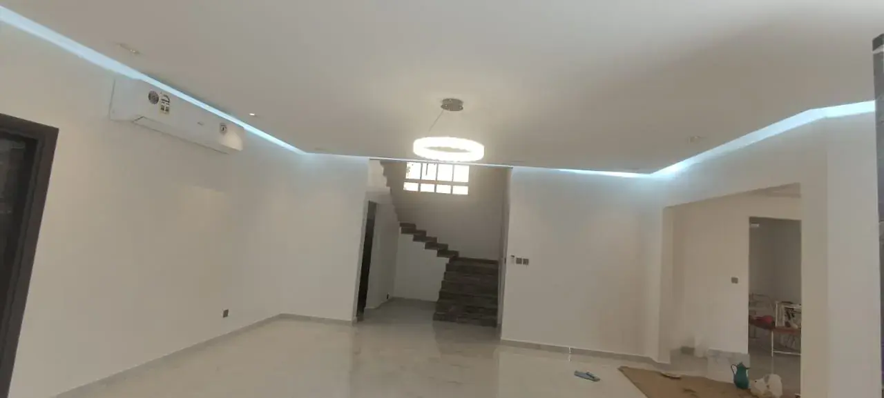 Finished hall with ceiling light and cove lighting