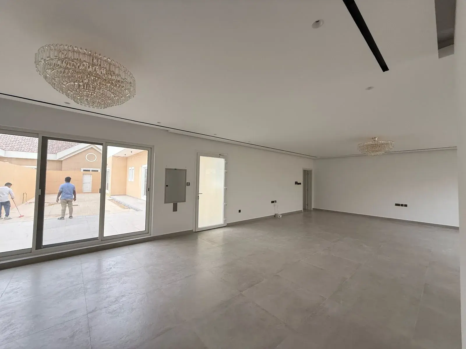 Bright living room with porcelain floor tiles and sliding doors