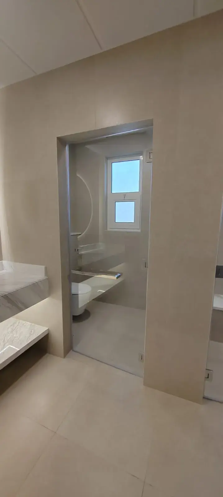 Bathroom with marble-look tiles and doorway