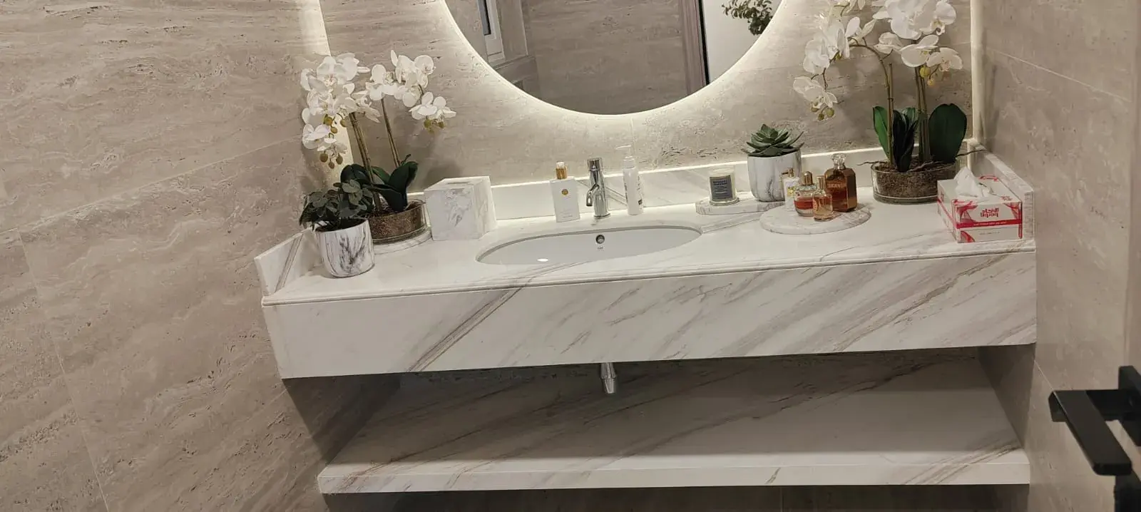 Marble vanity with round backlit mirror