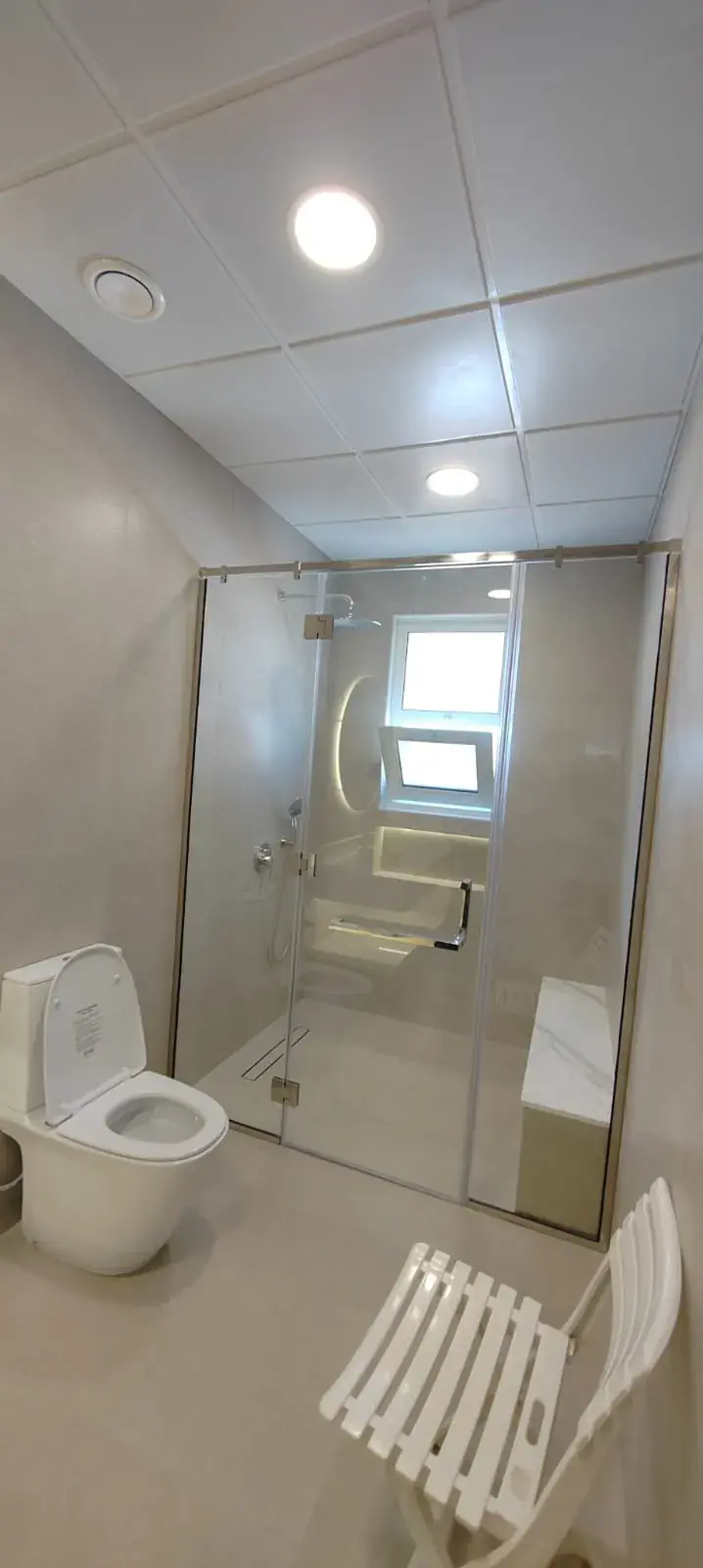 Bathroom with glass shower screen and window